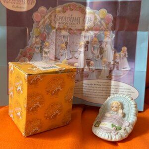 1983 Enesco Growing Up Birthday Girls Blond Baby in Basket Cradle Porcelain